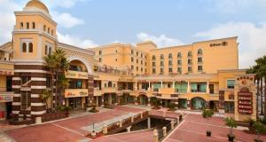 a large building with a courtyard in front of it at Valley Hotel in Rosemead