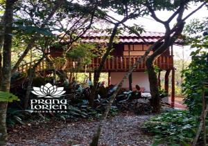 a resort with a building in the middle of trees at Pousada Spa Prana Lorien in Santo Antônio do Leite