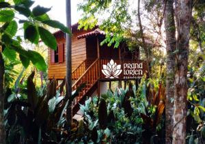 a resort with a sign in front of a building at Pousada Spa Prana Lorien in Santo Antônio do Leite