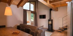 a living room with a dining room table and a fireplace at 3 Chalets Aparthotel in Breuil-Cervinia