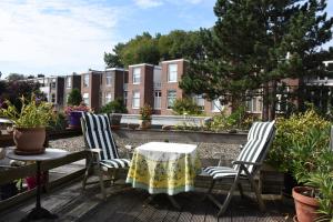 two chairs and a table on a patio at Bed & Breakfast Leonie in The Hague