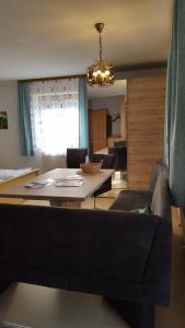 ein Wohnzimmer mit einem Sofa und einem Tisch in der Unterkunft Appartementhaus Elisabeth Winklhofer in Bad Füssing