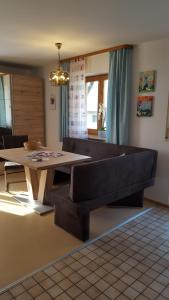 salon ze stołem i kanapą w obiekcie Appartementhaus Elisabeth Winklhofer w mieście Bad Füssing