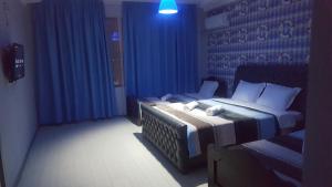 Säng eller sängar i ett rum på Hotel Cruise