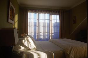 Krevet ili kreveti u jedinici u okviru objekta Hotel Manoir Atkinson