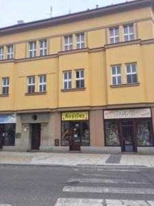 a yellow building on the side of a street at Apartmán na náměstí in Soběslav
