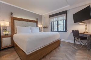 a bedroom with a bed and a desk with a computer at Westgate New York Grand Central in New York