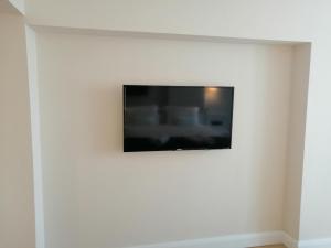 a television on a white wall in a room at ORBi CITY TOWERS in Batumi