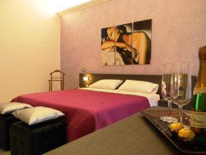 パレルモにあるB＆B オレート チェントロのベッド、テーブル(ワイングラス付)が備わる客室です。