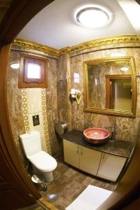 a bathroom with a toilet and a sink and a mirror at The Pashas House in Istanbul