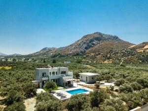 an aerial view of a house with a mountain at Villa Anemolia in Lefkogeia