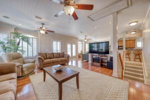 a living room with a couch and a table at Sunset Breeze in Panama City Beach
