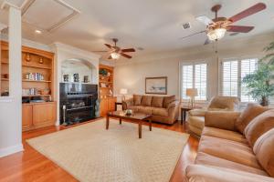 a living room with a couch and a fireplace at Sunset Breeze in Panama City Beach