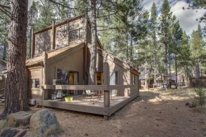 a cabin in the woods with a tree at 21 Pole House Lane in Sunriver