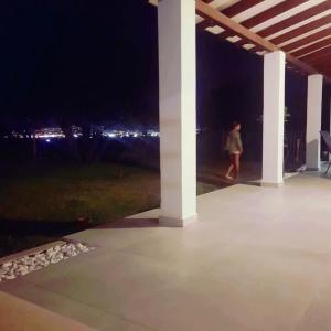 a person walking on a patio at night at Villa with fantastic view in Perea