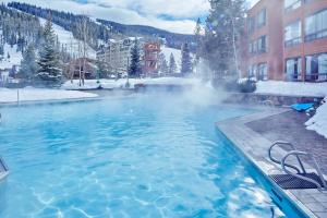 a hot tub with snow on top of it at Slopeside in Big Sky in Big Sky Mountain Village