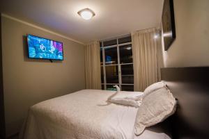 Ένα ή περισσότερα κρεβάτια σε δωμάτιο στο Hostal Montalvo