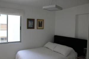 Cama o camas de una habitación en Apartamentos Temporales en Miraflores