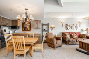 a kitchen and living room with a table and chairs at Shoshone 1986 in Big Sky