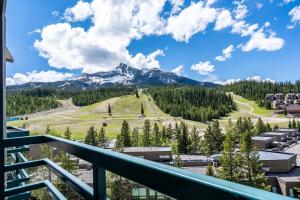 a view from the balcony of a resort with a mountain at Shoshone 1986 in Big Sky