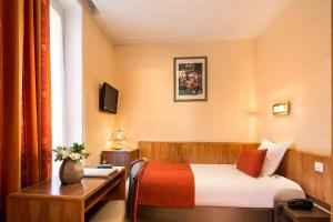 Säng eller sängar i ett rum på Hotel Terminus Lyon