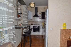 a kitchen with a bar with stools in it at Greenhouse in Kropyvnytskyi