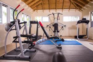 a gym with two exercise bikes and a treadmill at GC Resort in St Mary
