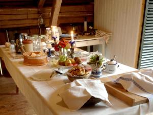 a table with food on it in a kitchen at Wiborggården Bed and Breakfast in Boda