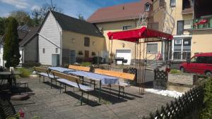 a group of tables and benches in a backyard at Hübinger Treff in Hübingen