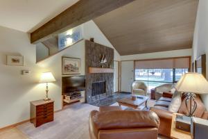 a living room with a couch and a fireplace at Meadow House 76 | Discover Sunriver in Sunriver