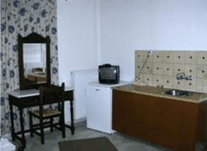 米里納的住宿－卡扎拉奇福提尼公寓，厨房配有水槽、桌子和镜子