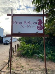 a sign for a spa resort on the side of a road at Apartamento A-11 Pipa Beleza Resort in Pipa