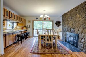 a kitchen and dining room with a table and a fireplace at Poplar 12 | Discover Sunriver in Sunriver