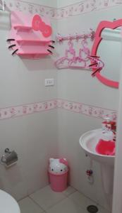a pink bathroom with a sink and a toilet at Hello Kitty at Wind Residences Tagaytay in Tagaytay
