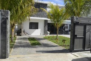 a house with palm trees and a driveway at Mont Choisy Azura in Mont Choisy