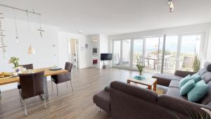 a living room with a couch and a table at Seesichtpur Wohnung Kaiser in Pelzerhaken