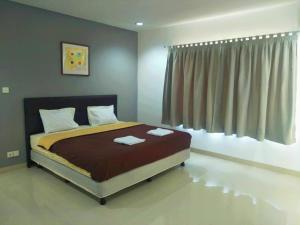 um quarto com uma cama com duas toalhas em Villa Kaca em Tanjung Lesung
