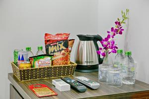 a table topped with a basket of food and drinks at Osaka Hotel Da Nang in Danang
