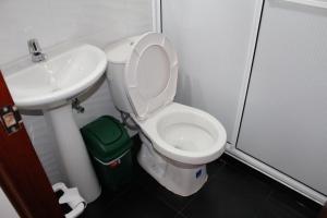 a bathroom with a toilet and a sink at Hotel La Ceiba in Valparaíso