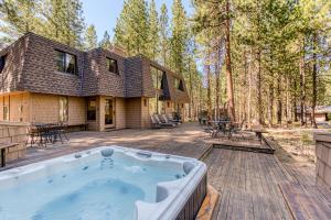 a house with a hot tub on a wooden deck at Black Butte Ranch: Hawks Beard Home in Black Butte Ranch