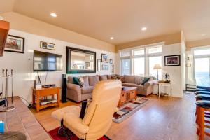 a living room with a couch and a tv at Surf's Edge in Rockaway Beach