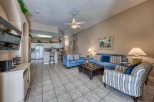 a living room with blue couches and a kitchen at Windstar Villa in Davenport