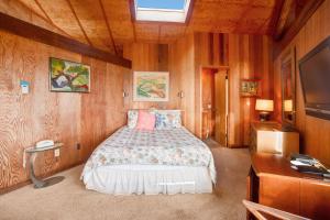a bedroom with a bed and a television in it at Curtis-Moulton Retreat in Sea Ranch