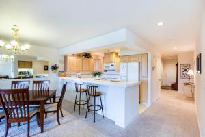 a kitchen and dining room with a table and chairs at Arrow Point Apartments in Twin Beaches