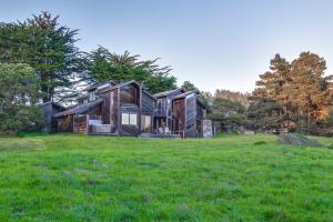 a house in a field with green grass at Vista Grande in Sea Ranch