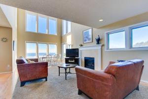 a living room with two chairs and a fireplace at Annie's Windsong in Lincoln City