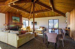 a living room with a couch and a table at Bovill on Shell Beach in Sea Ranch