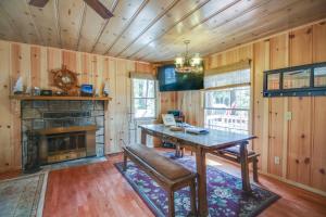 a dining room with a table and a fireplace at Cozy Bobby Grey Manor in South Lake Tahoe