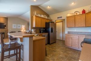 a kitchen with wooden cabinets and a refrigerator at East Wenatchee Serenity Hills in East Wenatchee Bench