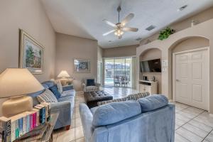a living room with blue couches and a ceiling fan at Windstar Villa in Davenport